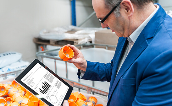 A man looking at a tablet screen with a chart